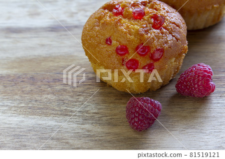 Gluten free almond flour cupcake, muffins with raspberries. Copy space, light wooden background 81519121