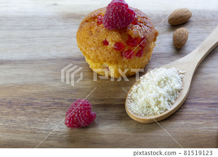 Gluten free almond flour cupcake, muffins with raspberries. Copy space, light wooden background 81519123