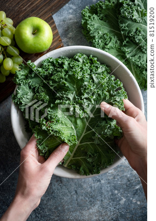 Woman washing kale cabbage leaf Woman washing kale cabbage leaf 81519200