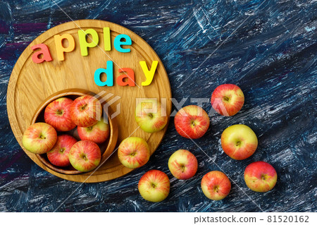 Apple is a national holiday on October 21. Red apples on a dark background. Top view Apple is a national holiday on October 21. Red apples on a dark background. Top view 81520162
