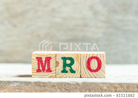 Alphabet letter block in word MRO (Abbreviation of Maintenance, repair and overhaul or Maintenance, Repair and Operations) on wood background 81521882