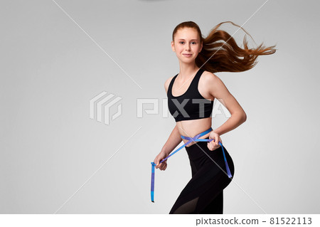 woman with perfect body in black bodysuit with measuring tape 81522113