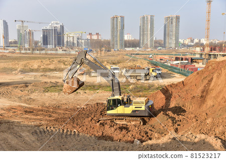 Excavator during earthmoving work at construction site. Excavator during earthmoving work at construction site. 81523217