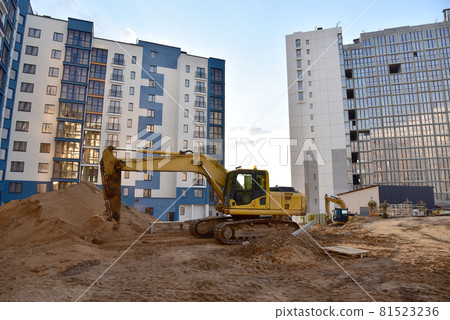 Excavator on earthworks. Laying heating pipes and stormwater in trench.  81523236