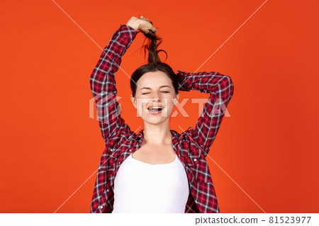Young beautiful smiling girl isolated on colorful studio background 81523977