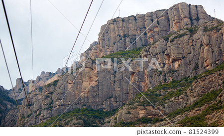 Yellow cable car in the Aeri de Montserrat rise to de Montserrat Abbey near Barcelona, Spain, Catalonia. 81524399