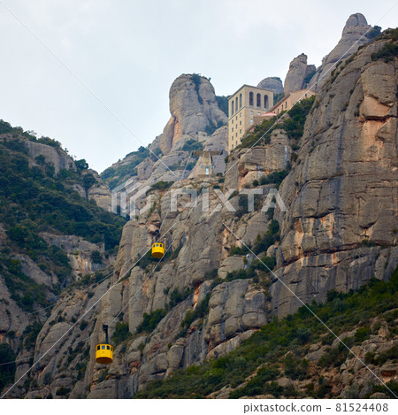 Yellow cable car in the Aeri de Montserrat rise to de Montserrat Abbey near Barcelona, Spain, Catalonia. 81524408