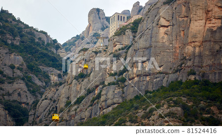 Yellow cable car in the Aeri de Montserrat rise to de Montserrat Abbey near Barcelona, Spain, Catalonia. 81524416