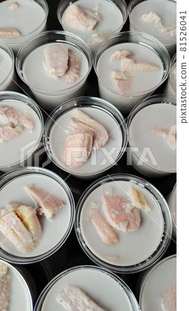Banana in coconut milk, famous native Thai style dessert made from natural ingredients in plastic container ready for delivery. 81526041