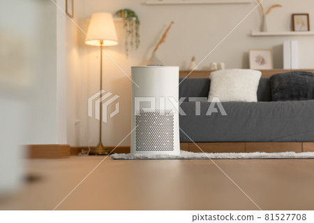 Air purifier in cozy white living room for filter and cleaning removing dust PM2.5 HEPA and virus in home,for fresh air and healthy Wellness life,Air Pollution Concept 81527708
