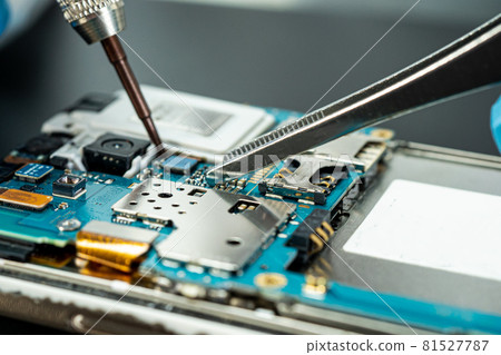 technician repairing inside of hard disk by soldering iron. Integrated Circuit. the concept of data, hardware, technician and technology. 81527787