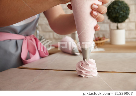 Confectioner making marshmallow desserts with pastry bag 81529067