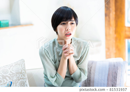 Young woman praying with folded hands Young woman praying with folded hands 81531937