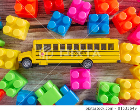 Color toy bricks and school bus on wood table for background or education concept Color toy bricks and school bus on wood table for background or education concept 81533649