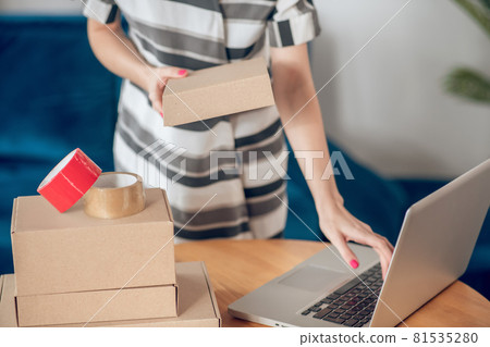Busy small business owner working on her laptop Busy small business owner working on her laptop 81535280
