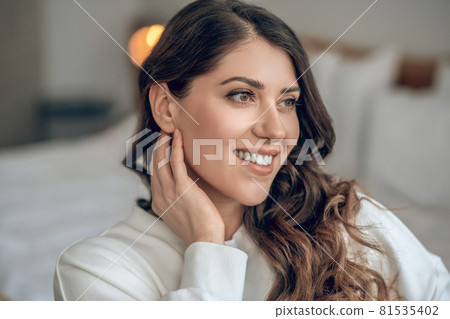 Pretty young long-haired woman in a white blouse Pretty young long-haired woman in a white blouse 81535402