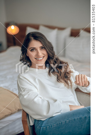 Pretty young long-haired woman in a white blouse Pretty young long-haired woman in a white blouse 81535403