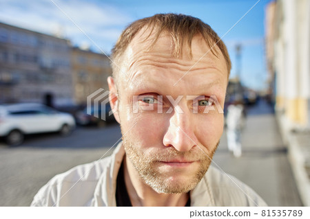 Portrait of white man on city street at daytime. 81535789