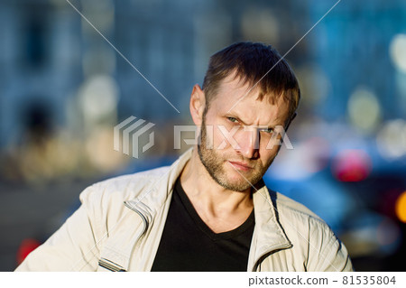 Portrait of frowning white man with stubble on face. Portrait of frowning white man with stubble on face. 81535804
