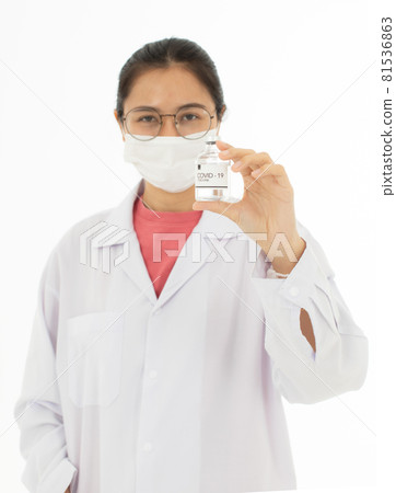 Portrait of Asian female doctor in white gown coat wearing eyes glasses in white background holding bottle of coronavirus covid 19 vaccine Portrait of Asian female doctor in white gown coat wearing eyes glasses in white background holding bottle of coronavirus covid 19 vaccine 81536863