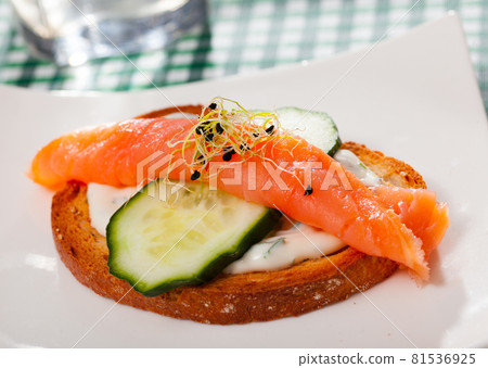 Sandwich with salmon, cucumber, sauce 81536925