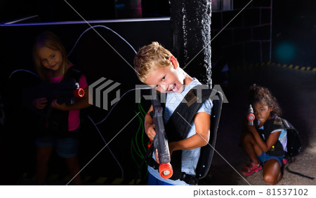Portrait of fine tweenager boy with laser gun 81537102