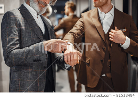 Senior man choosing a new suit in a store Senior man choosing a new suit in a store 81538494