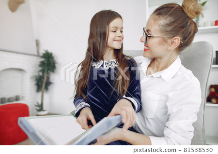 Tutor with litthe girl studying at home Tutor with litthe girl studying at home 81538530