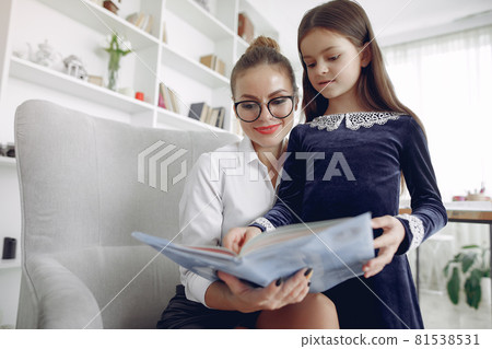 Tutor with litthe girl studying at home Tutor with litthe girl studying at home 81538531
