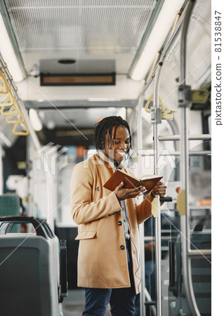 Young African businessman standing on a bus 81538847