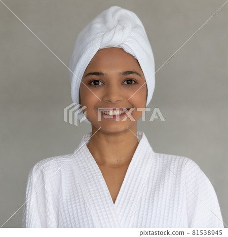 Cute teen Asian woman with white towel folding around head in white spa dress Cute teen Asian woman with white towel folding around head in white spa dress 81538945