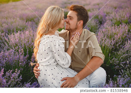 Woman in a white dress with her husband in a lavender field Woman in a white dress with her husband in a lavender field 81538946