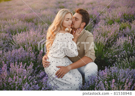 Woman in a white dress with her husband in a lavender field Woman in a white dress with her husband in a lavender field 81538948