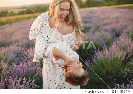 Little boy with her mother in a lavender field Little boy with her mother in a lavender field 81538949