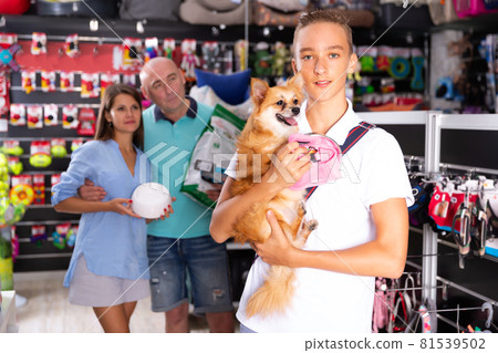 Fine teenage boy and family choosing accessories Fine teenage boy and family choosing accessories 81539502
