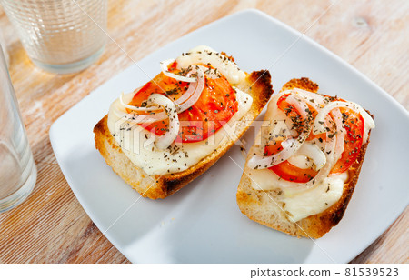 Toasted bread with cheese, onion and tomato Toasted bread with cheese, onion and tomato 81539523