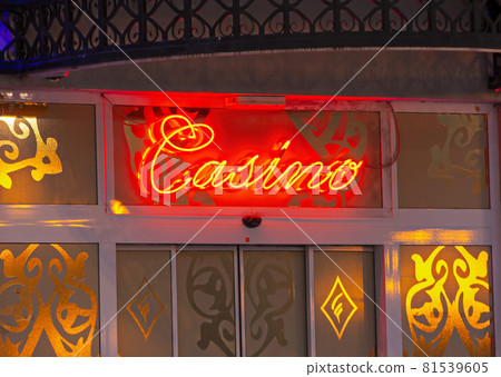 Yellow and red neon lights surround casino sign. Selective focus 81539605