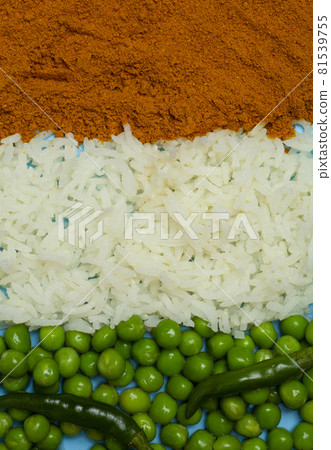 Indian flag made from food background. Basmati rice, curry, green peas and chili peppers in the colors of the Indian flag on a blue background. Indian flag made from food background. Basmati rice, curry, green peas and chili peppers in the colors of the Indian flag on a blue background. 81539755