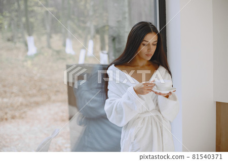 Picture of beautiful woman in white bathrobe 81540371
