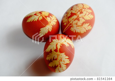 Painted Easter eggs on a white background. Floral pattern on a red eggshell. Festive food. Painted Easter eggs on a white background. Floral pattern on a red eggshell. Festive food. 81541164