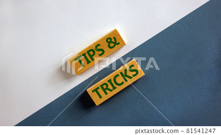 Tips and tricks symbol. Wooden blocks with words 'Tips and tricks'. Beautiful white and blue background. Business, tips and tricks concept. Copy space. 81541247