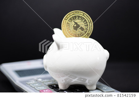 White piggy Bank and gole bitcoin stand on the calculator and black background. White piggy Bank and gole bitcoin stand on the calculator and black background. 81542159
