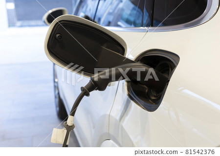 Electric car charging in power station. Electric car charging in power station. 81542376