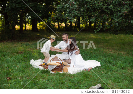 Happy family having picnic outdoors with their Happy family having picnic outdoors with their 81543022