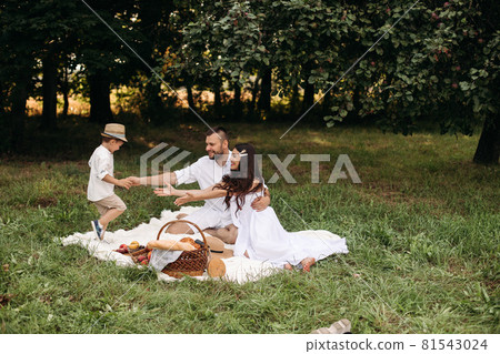 Happy family having picnic outdoors with their Happy family having picnic outdoors with their 81543024