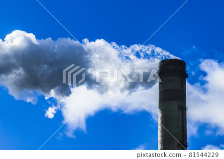Environmental pollution, environmental problem, smoke from the pipe of an industrial plant or thermal power plant against a blue sky 81544229