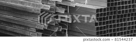 A pile of metal plates and square industrial pipes. Building materials at the construction site 81544237