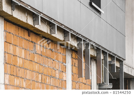 Facade repair brick wall of a new modern unfinished building, high-rise city house reconstruction Facade repair brick wall of a new modern unfinished building, high-rise city house reconstruction 81544250