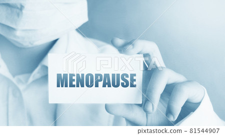 Menopause concept written on a card in doctors hand. Woman health concept Menopause concept written on a card in doctors hand. Woman health concept 81544907