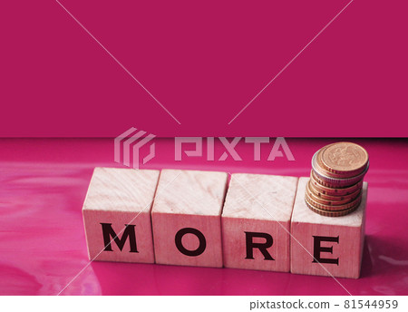 More word on wooden cubes on computer keyboard and coins. Investment and saving financial concept. Selective focus. 81544959